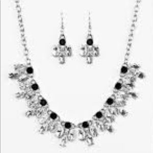 Glittery white rhinestones flare from the bottom of classic black rhinestones.